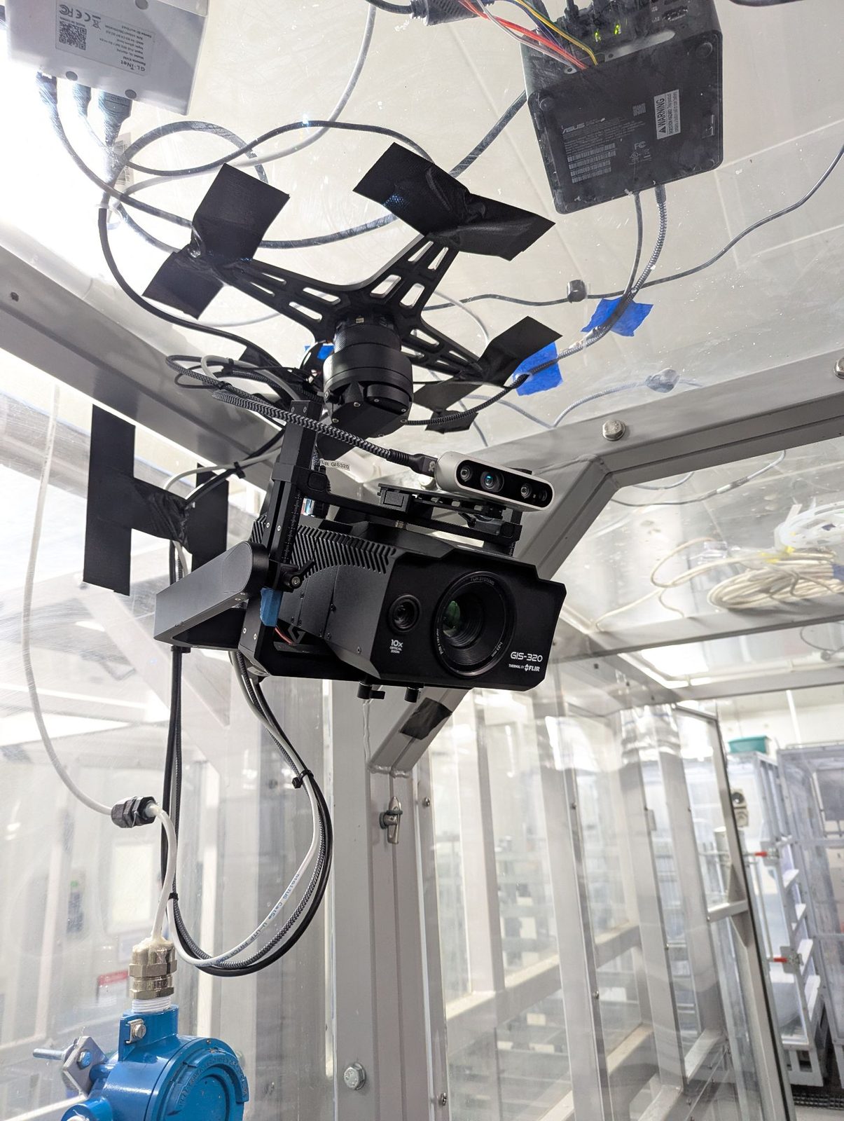 The camera package with gimbal mounted above the stall, looking down.